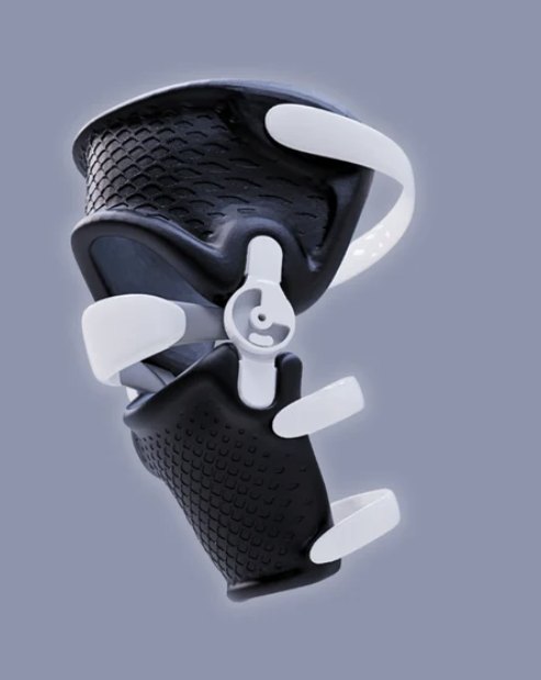 A black 3D-printed knee brace with white hinge and straps.